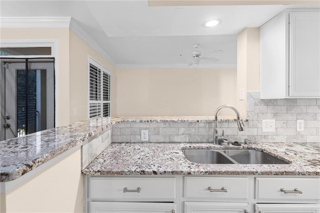 3777 Peachtree Road Northeast, Unit 1529 Atlanta, GA 30319 - Photo 13 of 45 a kitchen with granite countertop a sink and cabinets