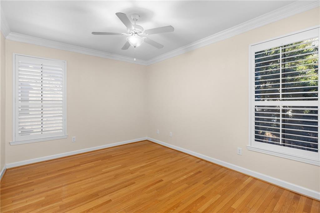 3777 Peachtree Road Northeast, Unit 1529 Atlanta, GA 30319 - Photo 14 of 45 a view of an empty room with wooden floor and a window