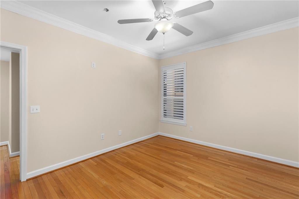 3777 Peachtree Road Northeast, Unit 1529 Atlanta, GA 30319 - Photo 16 of 45 a view of an empty room with wooden floor and a window