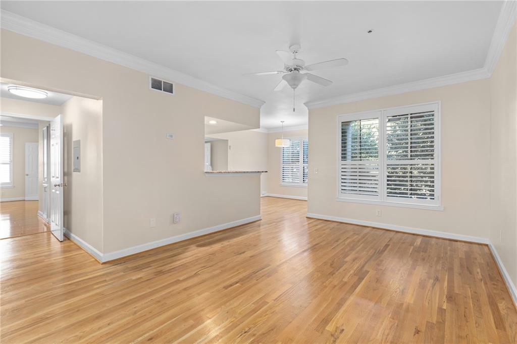 3777 Peachtree Road Northeast, Unit 1529 Atlanta, GA 30319 - Photo 2 of 45 a view of an empty room with wooden floor and a window
