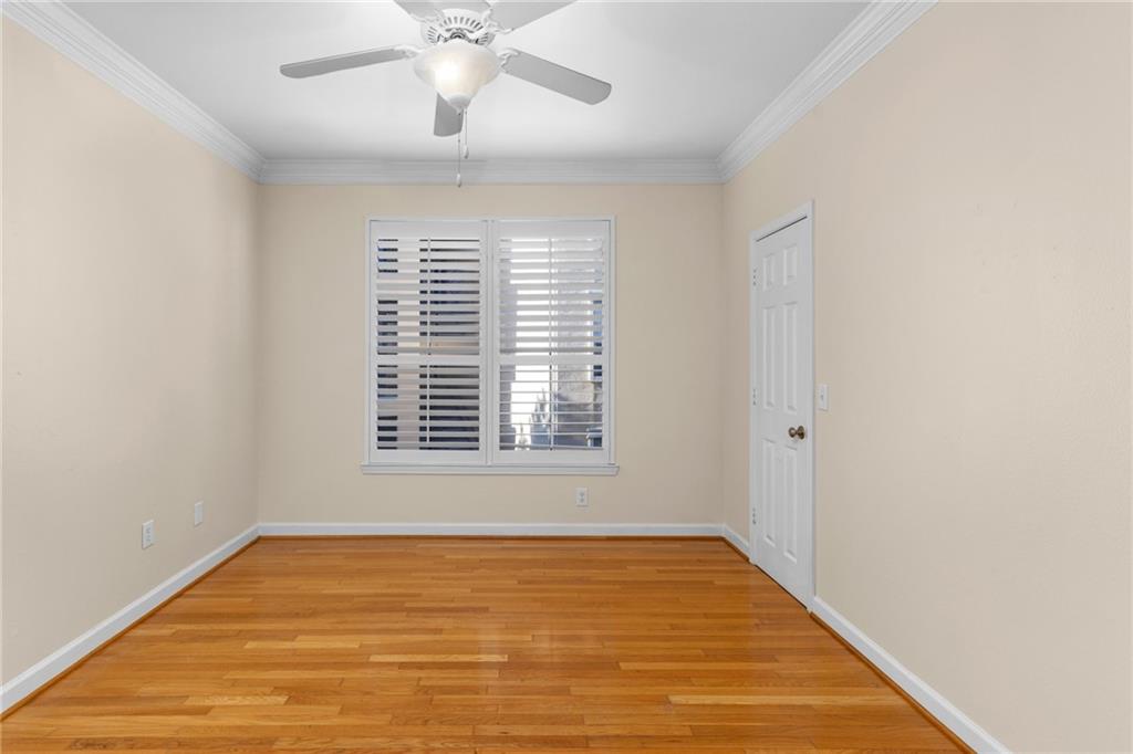3777 Peachtree Road Northeast, Unit 1529 Atlanta, GA 30319 - Photo 24 of 45 a view of an empty room with wooden floor and a window