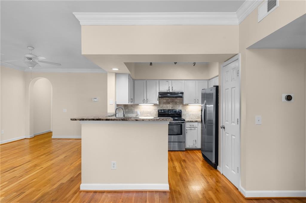 3777 Peachtree Road Northeast, Unit 1529 Atlanta, GA 30319 - Photo 9 of 45 a kitchen with stainless steel appliances granite countertop a refrigerator a stove top oven a sink and dishwasher