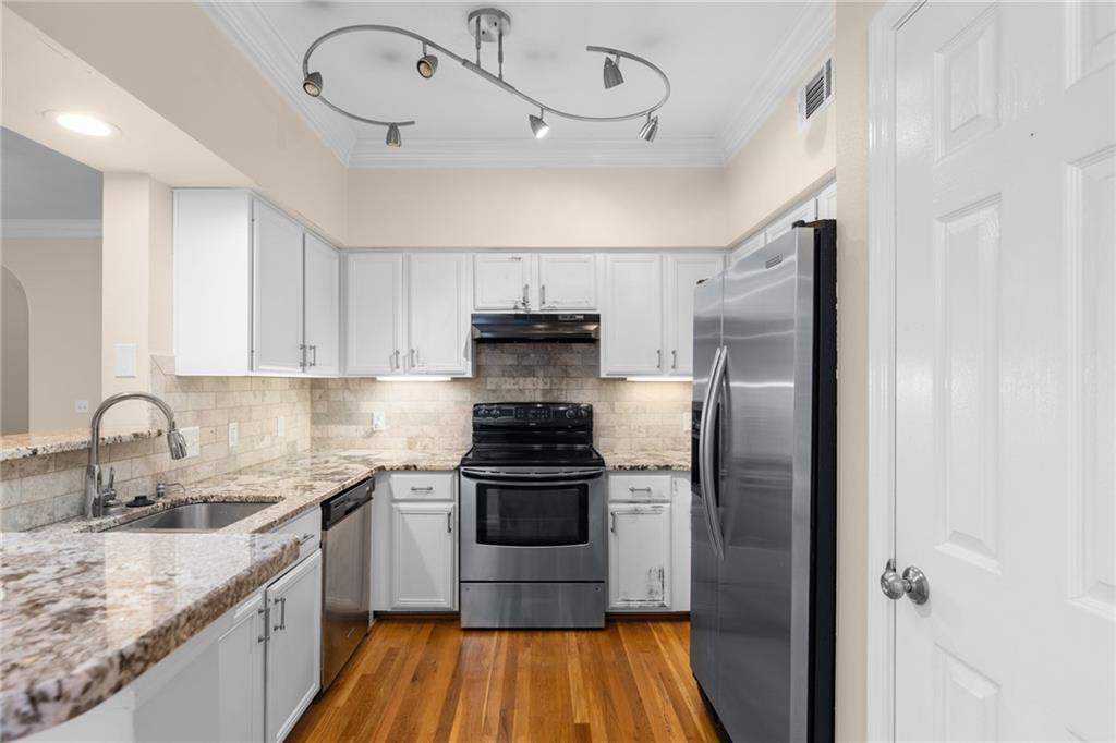 3777 Peachtree Road Northeast, Unit 1529 Atlanta, GA 30319 - Photo 10 of 45 a kitchen with stainless steel appliances granite countertop a sink stove and refrigerator