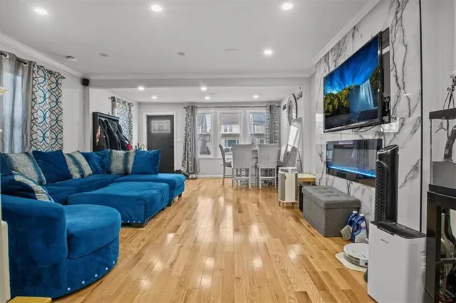 a living room with furniture a flat screen tv and a fireplace