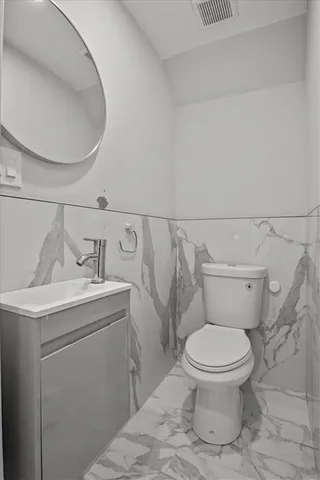 a bathroom with a toilet a sink and a mirror