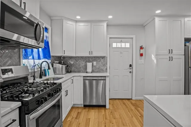 a kitchen with stainless steel appliances granite countertop a stove and a refrigerator