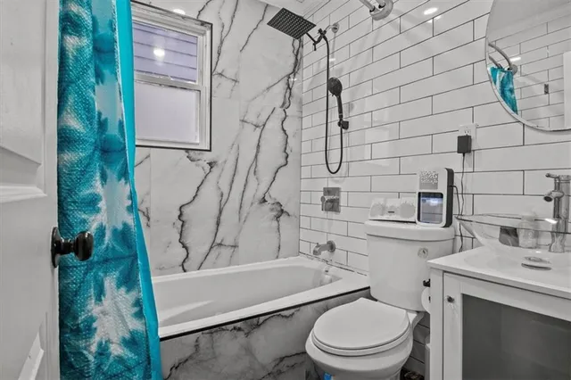 a bathroom with a toilet and a shower