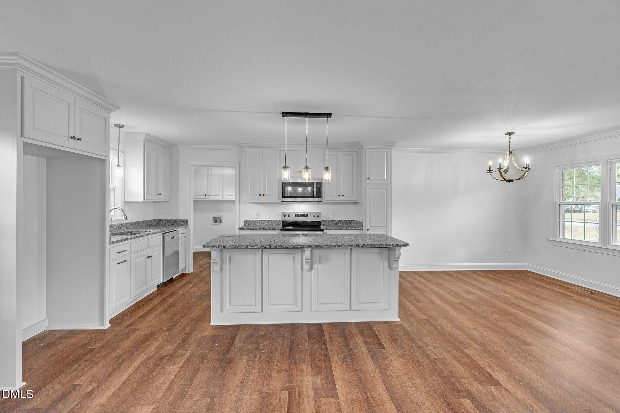 1219 Queen Anne Road Northwest Wilson, NC 27896 - Photo 24 of 26 a kitchen with granite countertop a sink cabinets and stainless steel appliances