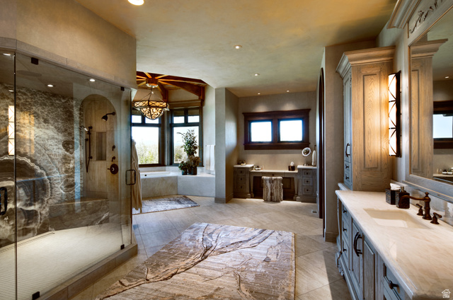 2322 North Westward Ho Road Heber City, UT 84036 - Photo 13 of 54 Bathroom with vanity, a garden tub, a marble finish shower, a chandelier, and light tile patterned floors