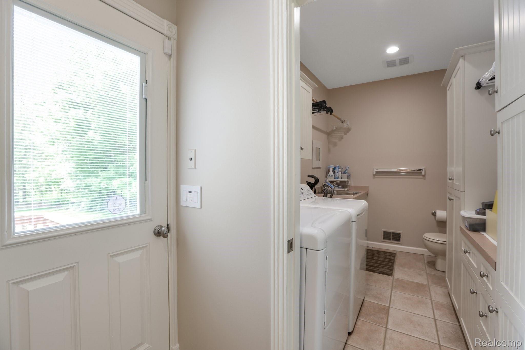 4808 Rivers Edge Drive Troy, MI 48098 - Photo 35 of 40 1st floor Laundry w/ built-in cabinetry and drying rack off mudroom