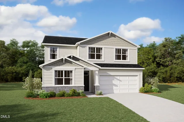 a front view of a house with a garden and yard