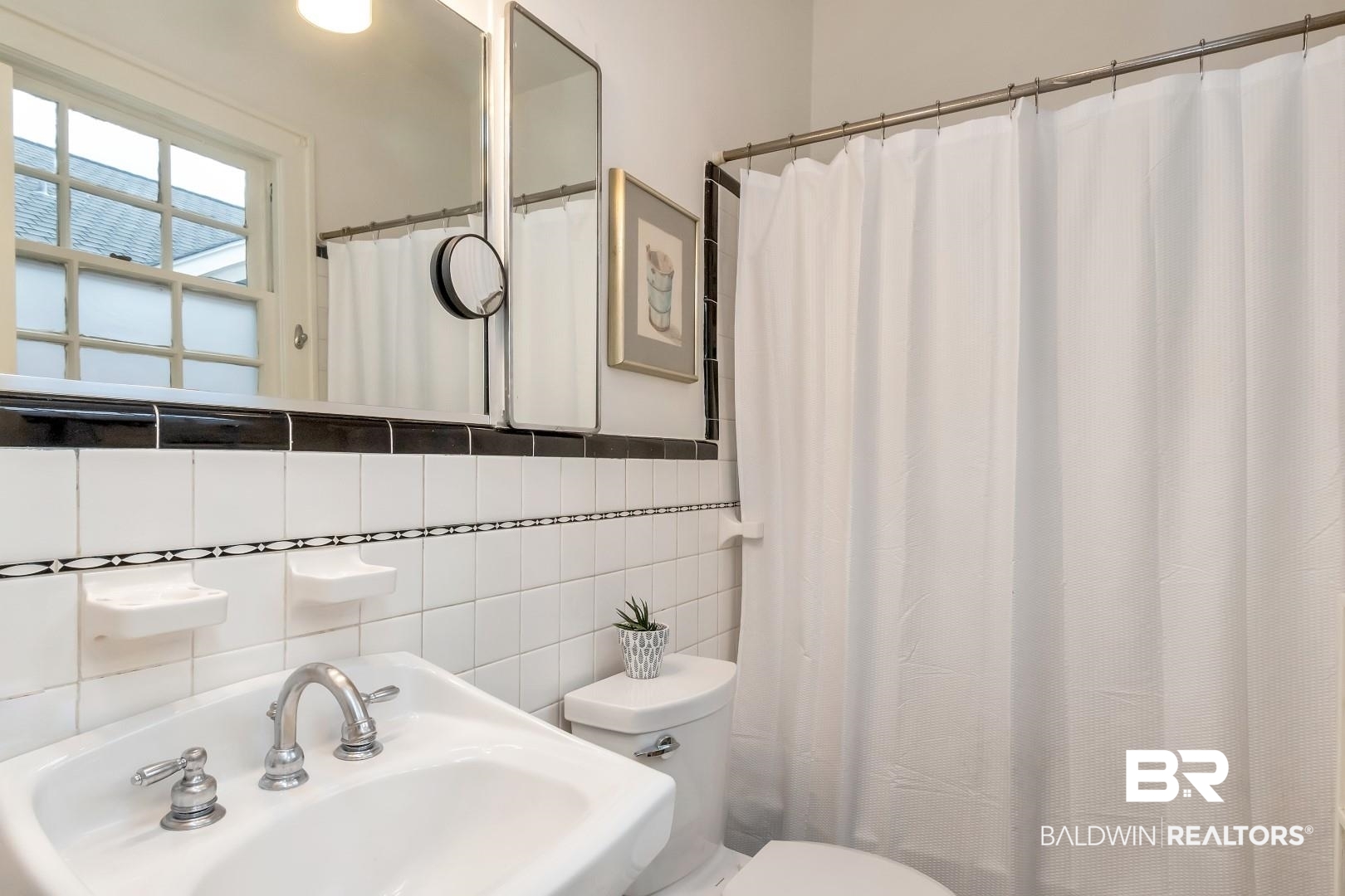 128 Silverwood Street Mobile, AL 36607 - Photo 19 of 34 Bathroom with a shower with shower curtain, toilet, sink, tile walls, and tasteful backsplash