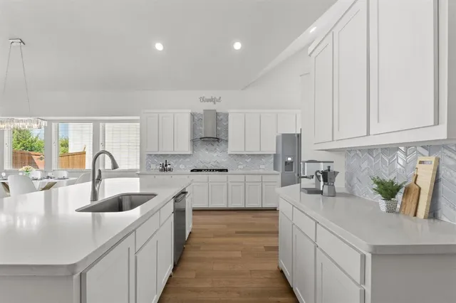 a kitchen with sink a stove and cabinets