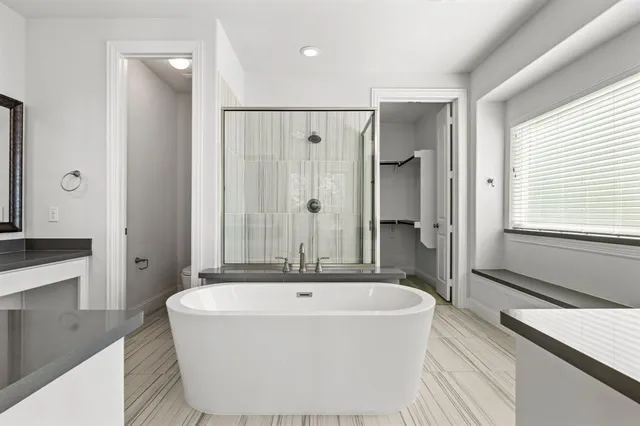 a white bath tub sitting in a en suite bathroom