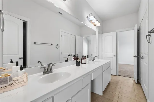 a bathroom with double vanity sinks a vanity a mirror and shower