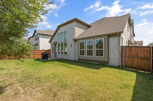 a view of a house with a garden and pathway