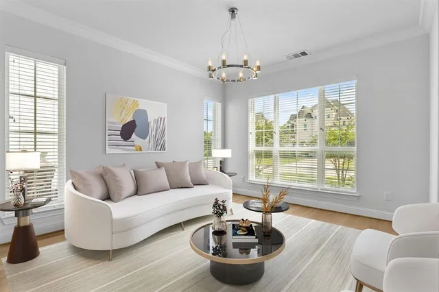 a living room with furniture a chandelier and a window