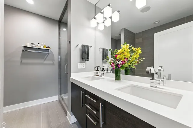 a bathroom with a sink double vanity and a mirror