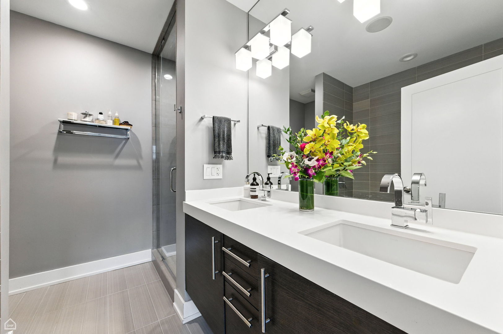 1312 West Madison Street, Unit 3A Chicago, IL 60607 - Photo 13 of 21 a bathroom with a sink double vanity and a mirror