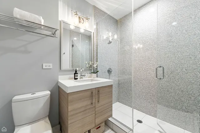 a bathroom with a sink toilet and shower