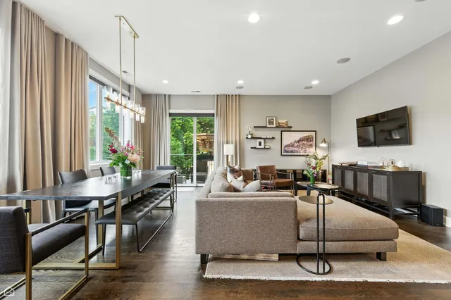 a living room with furniture a flat screen tv and a large window