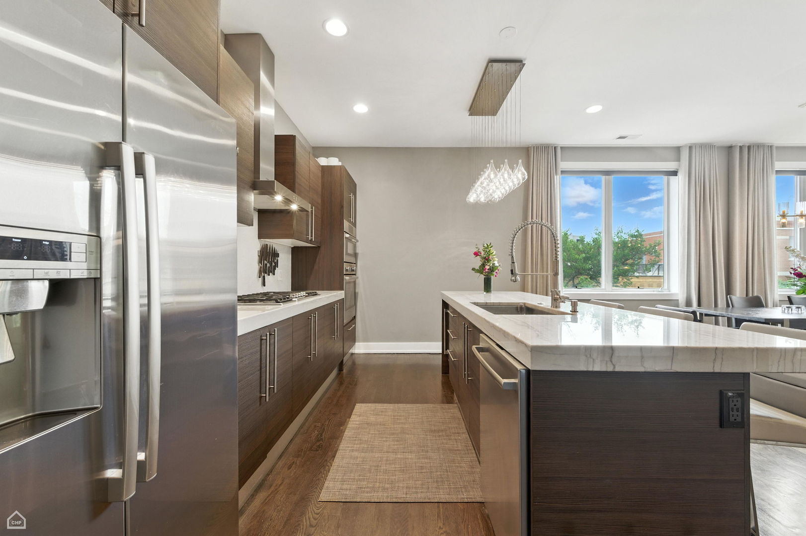 1312 West Madison Street, Unit 3A Chicago, IL 60607 - Photo 5 of 21 a kitchen with stainless steel appliances granite countertop a sink and a refrigerator