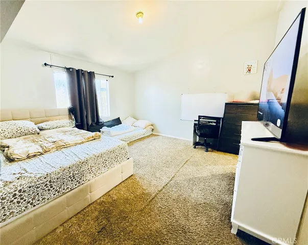 a bedroom with a bed and window