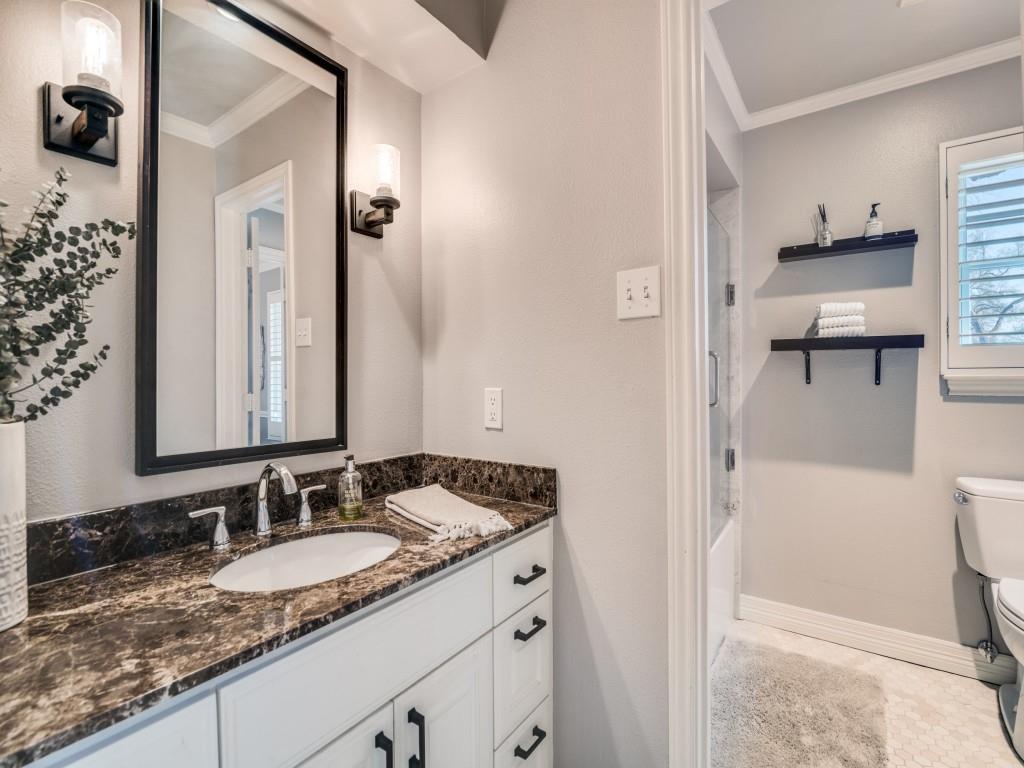 343 East Tripp Road Sunnyvale, TX 75182 - Photo 22 of 36 a bathroom with a granite countertop sink and a mirror
