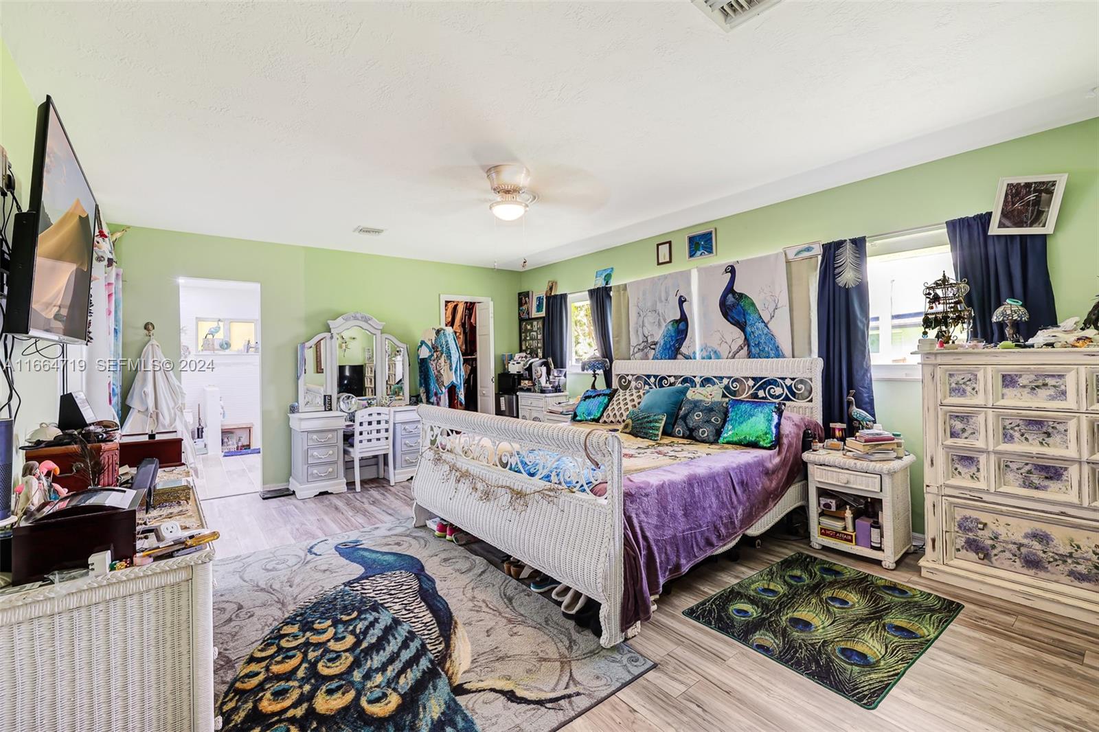 17421 Southwest 300th Street Homestead, FL 33030 - Photo 20 of 62 a bed room with a bed a flat screen tv and a couch