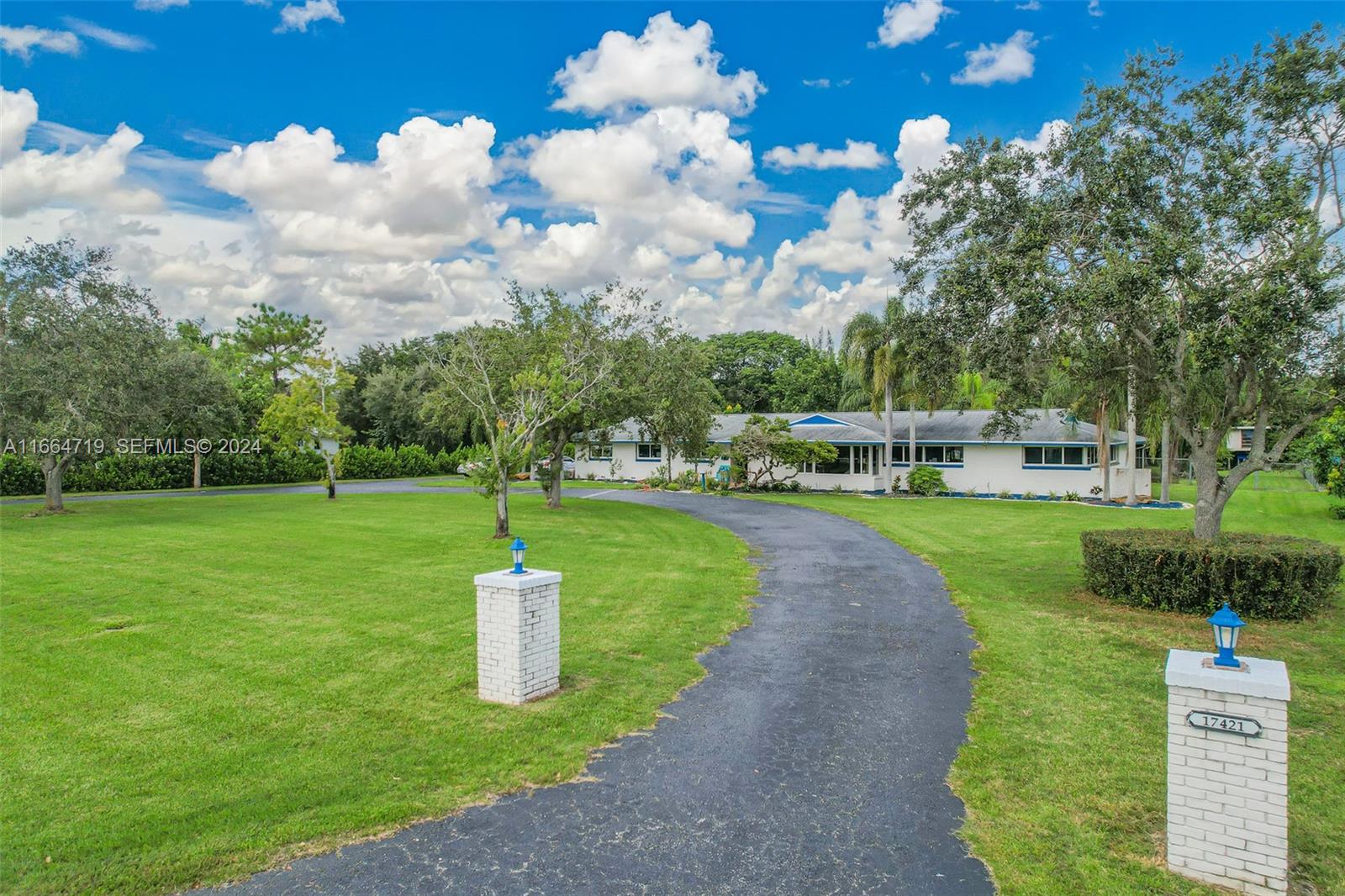 17421 Southwest 300th Street Homestead, FL 33030 - Photo 2 of 62 a green field with lots of tress in it