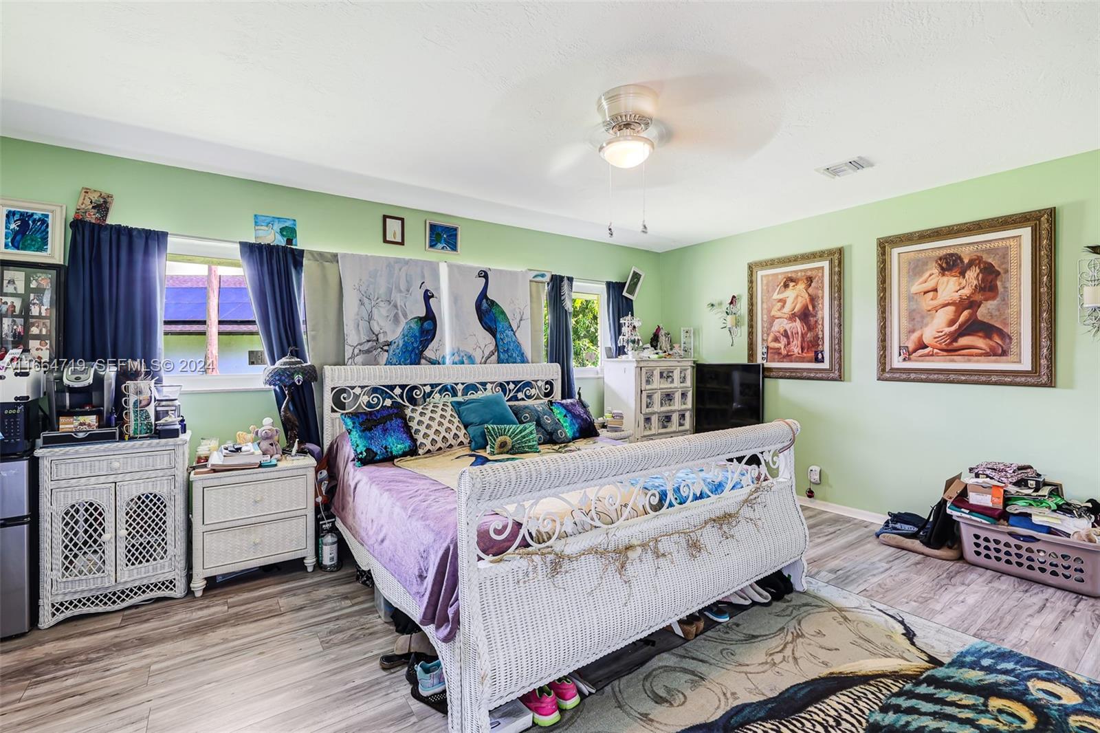 17421 Southwest 300th Street Homestead, FL 33030 - Photo 21 of 62 a bedroom with a bed and a chandelier