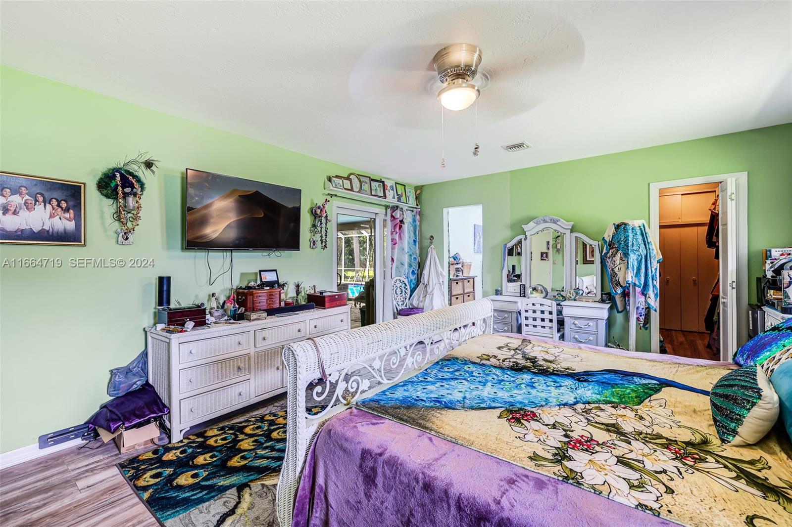 17421 Southwest 300th Street Homestead, FL 33030 - Photo 22 of 62 a bedroom with a bed and a flat screen tv