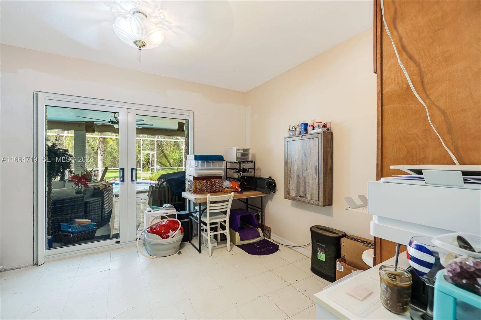 17421 Southwest 300th Street Homestead, FL 33030 - Photo 32 of 62 a view of a workspace with furniture and a window