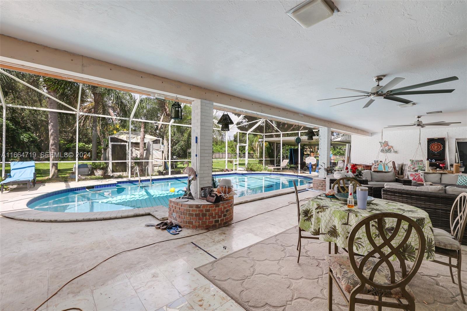 17421 Southwest 300th Street Homestead, FL 33030 - Photo 44 of 62 a living room with furniture and a large window