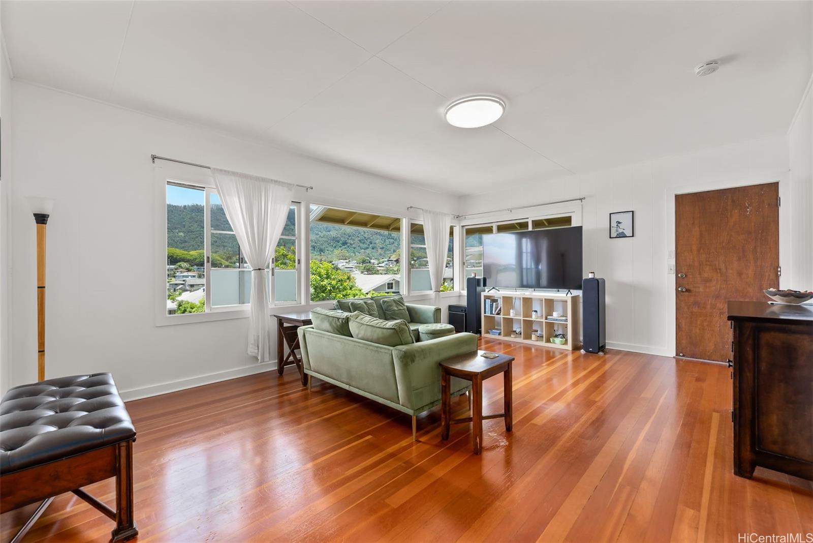2811 Henry Street Honolulu, HI 96817 - Photo 3 of 25 Upstairs, the main living room will take your breath away with its rich, gleaming wood floors and picture windows framing the mountains.