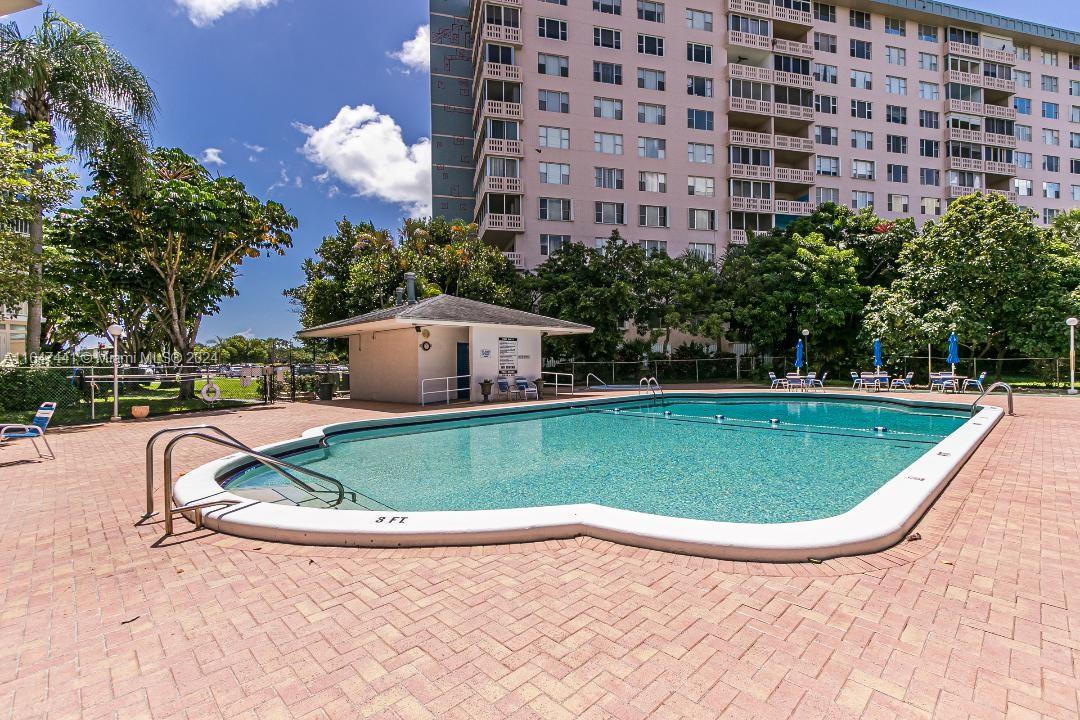 a view of a swimming pool and a yard