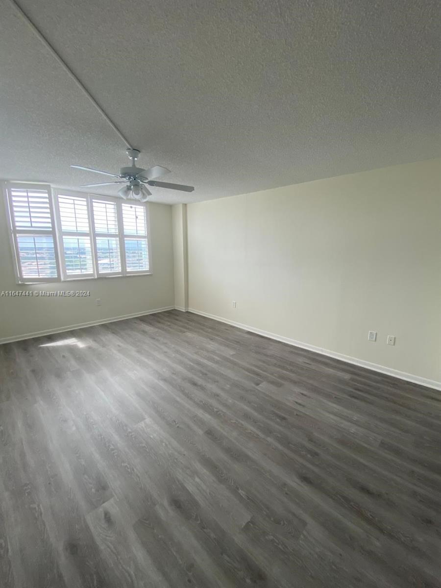 3850 Washington Street, Unit 1110 Hollywood, FL 33021 - Photo 12 of 29 an empty room with wooden floor and windows