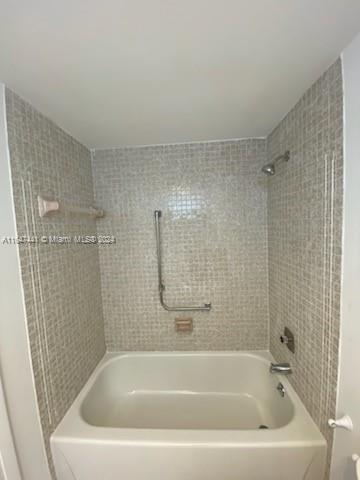 3850 Washington Street, Unit 1110 Hollywood, FL 33021 - Photo 16 of 29 a white bath tub sitting next to a white sink and vanity