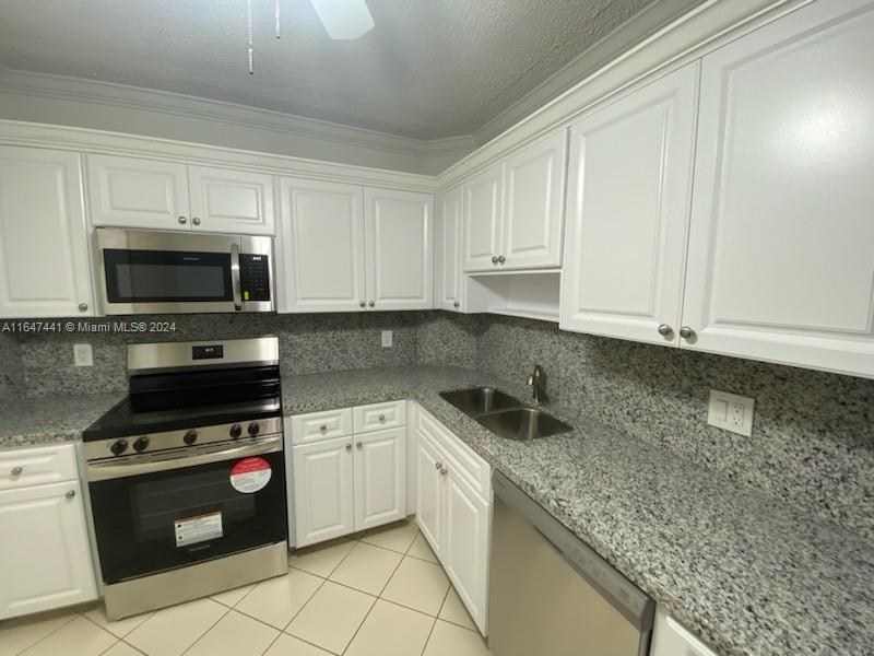 3850 Washington Street, Unit 1110 Hollywood, FL 33021 - Photo 2 of 29 a kitchen with sink a microwave and cabinets