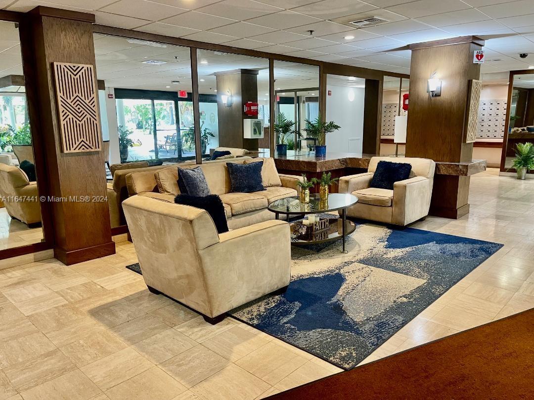 3850 Washington Street, Unit 1110 Hollywood, FL 33021 - Photo 28 of 29 a living room with furniture rug and a large window