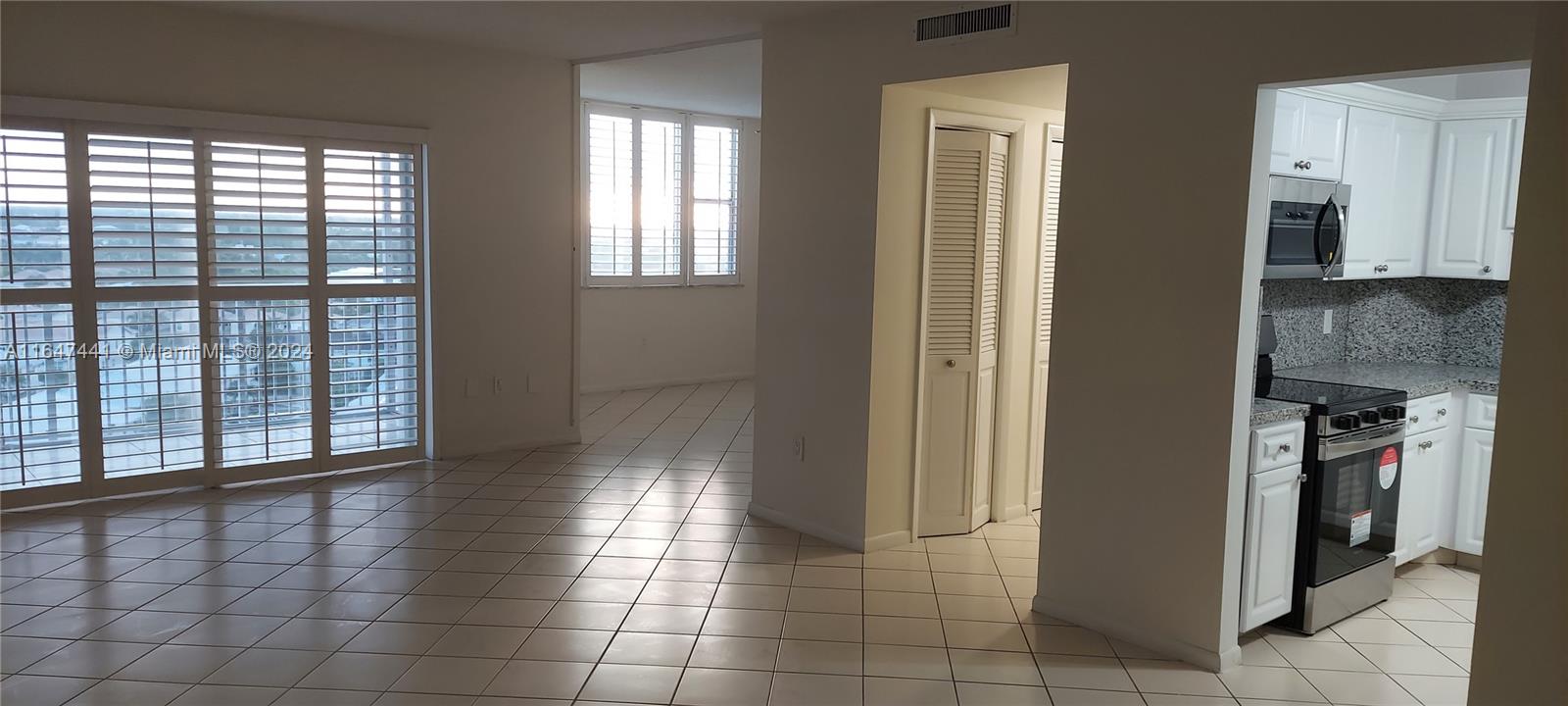 3850 Washington Street, Unit 1110 Hollywood, FL 33021 - Photo 6 of 29 a view of a hallway with entryway and dining area