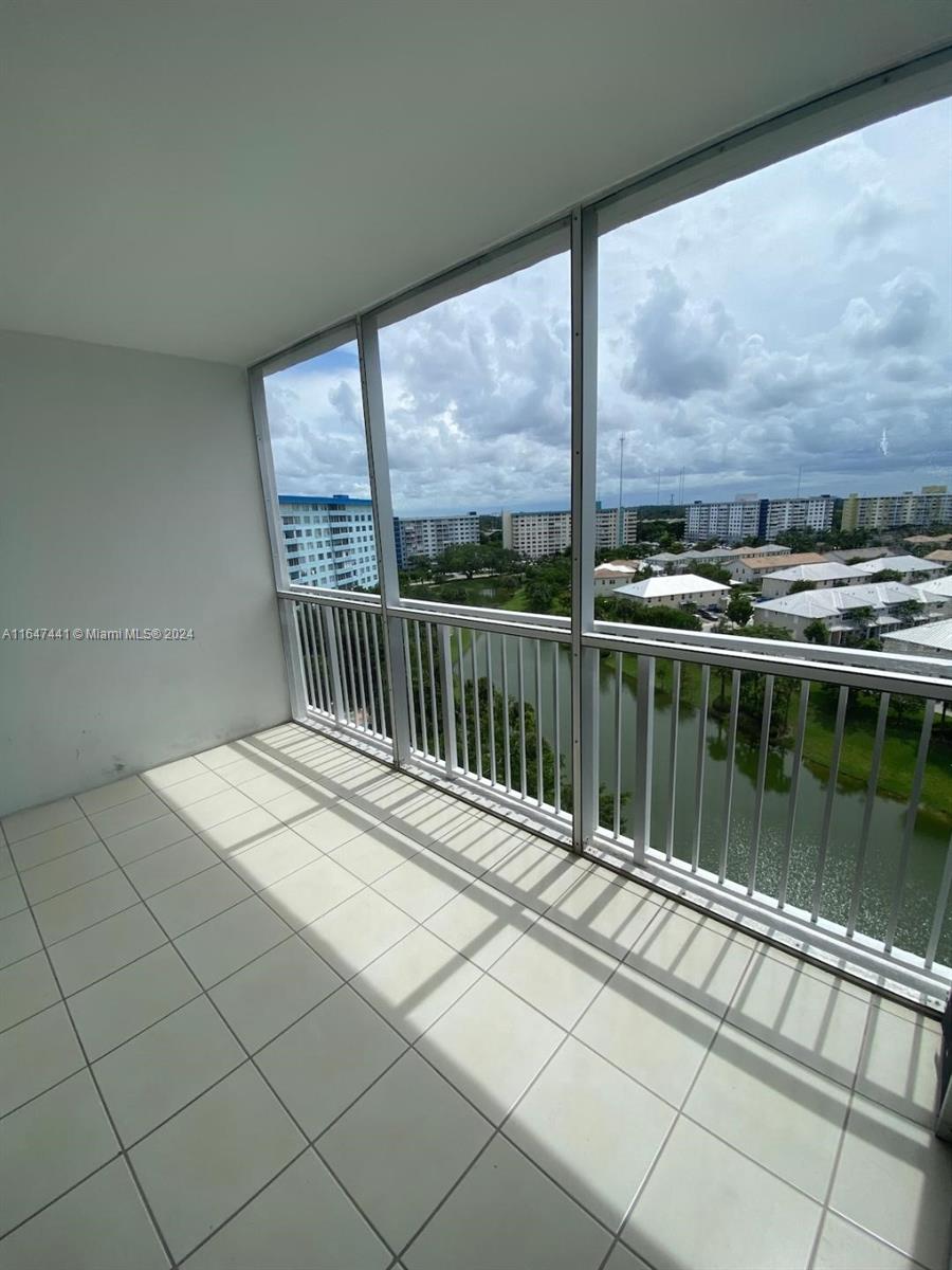 3850 Washington Street, Unit 1110 Hollywood, FL 33021 - Photo 7 of 29 a view of balcony with a floor to ceiling window next to a yard