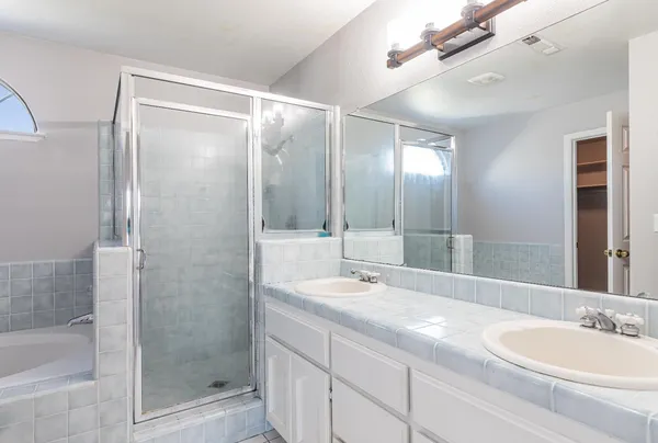 a bathroom with a double vanity sink and a mirror
