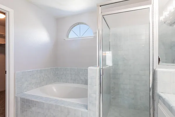 a bath tub sitting next to a shower