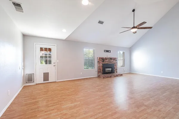 an empty room with furniture and a fireplace