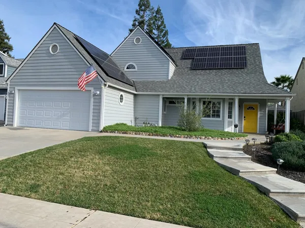 a front view of a house with garden