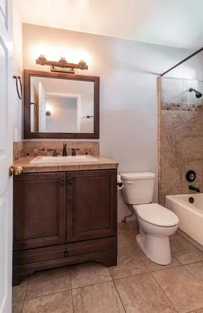 a bathroom with a stove a sink and a mirror
