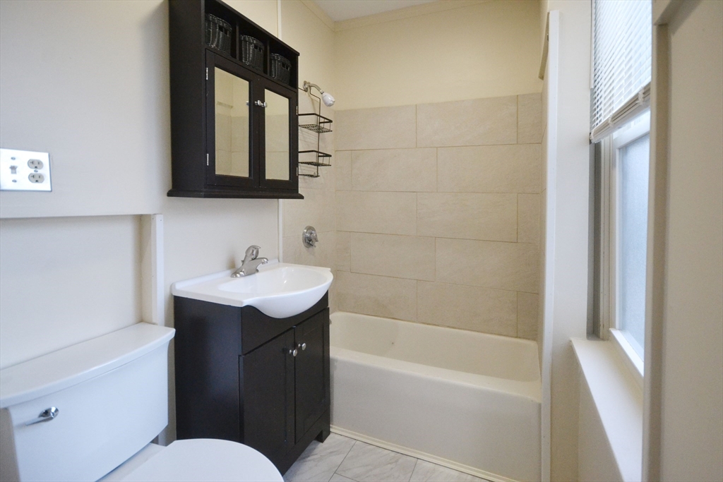 143 Arlington Street, Unit 1 Framingham, MA 01702 - Photo 12 of 20 a bathroom with a sink toilet tub and shower