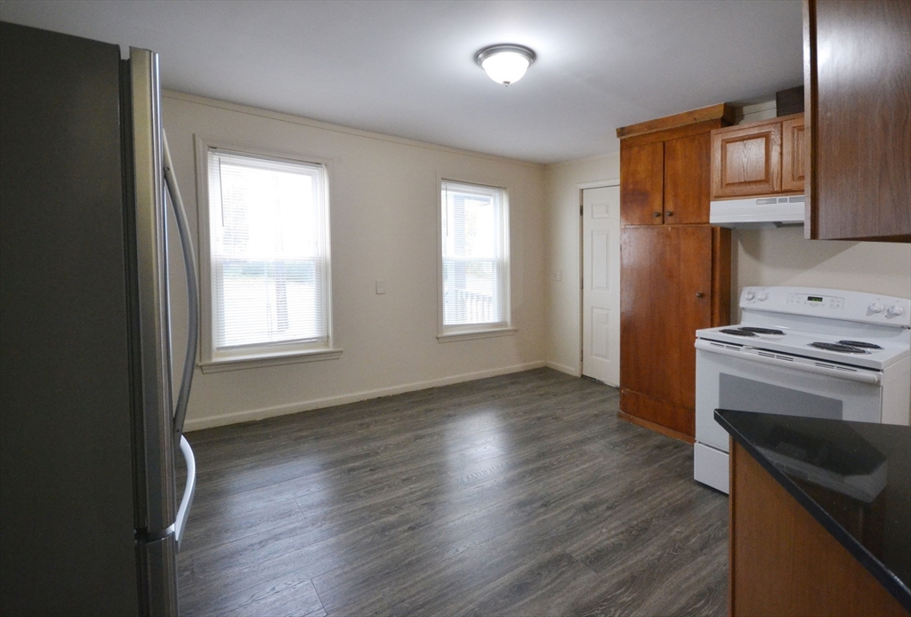 143 Arlington Street, Unit 1 Framingham, MA 01702 - Photo 4 of 20 an empty room with wooden floor and a window