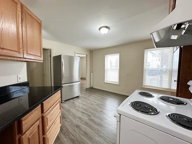 a kitchen with granite countertop a sink stainless steel appliances and cabinets